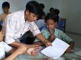 Teacher Helping Girls With School Work